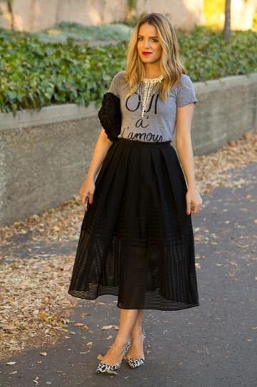outfit with graphic tee and black midi pleated skirt