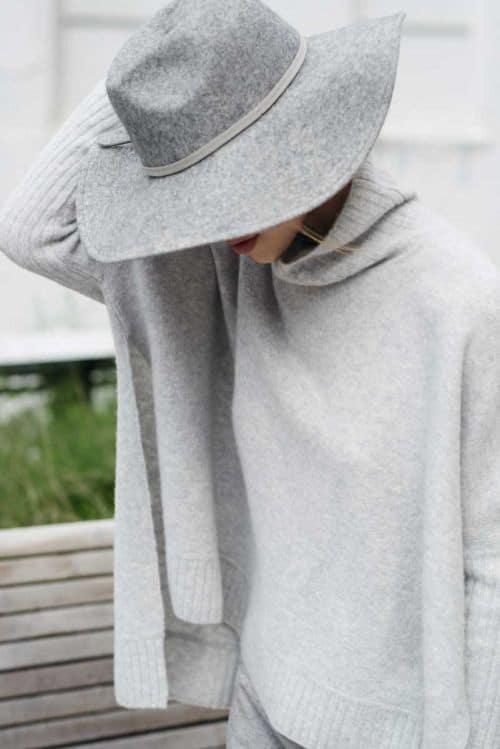 Light gray fedora hat with light gray poncho