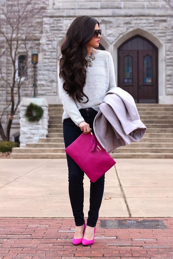 Magenta handbag with light gray sweater and magenta heels