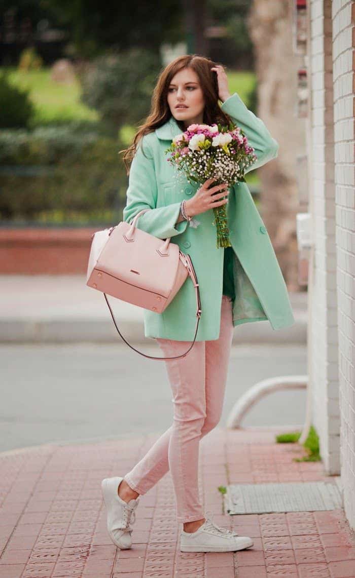 Light green duffle coat with light pink handbag and skinnies